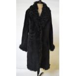 A Nicole Farhi black sheepskin coat with curly shearling lamb collar, cuffs and edges, 50 cm