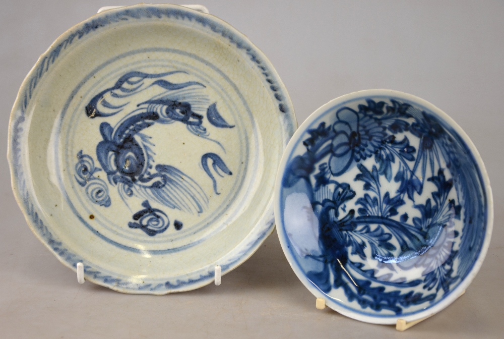 A Chinese blue and white shallow bowl decorated with a stylised bird amidst flowers and foliage, mid