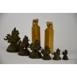 A set of six Asian graduated bronze weights in the form of a fabulous animal raised on an octagonal