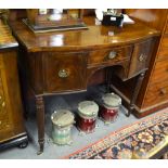 An early Victorian mahogany bowfront sideboard with a single drawer to an arched frieze flanked by