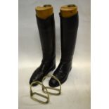 A pair of vintage military dress boots with brass ring-pull wooden boot trees,