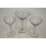 A garniture set of oversized goblet vases, the bowls etched with grapes and vine,