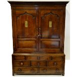 An 18th century jointed and panelled oak press cupboard,