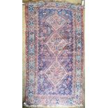 An antique Shiraz rug, the diamond pole design on blue/red ground, 178 x 100 cm Condition Report