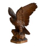 A finely-carved Black Forest oak spread eagle, perched on a rock, 42 x 43 cm,