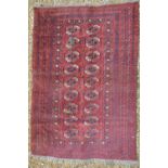 An old Turkoman rug, 2nd quarter 20th century, having two rows of geometric repeating guls on red-