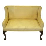 A walnut square wing chair back settee in the George I style, raised on carved cabriole front legs