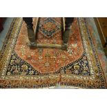 An antique Shiraz rug, S W Persia circa 1900, the geometric medallion design on mid-red ground, 2.40