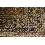 An old Indo-Persian Tabriz carpet, the floral design on brown/cinnamon ground, 3.75 x 2.80 m