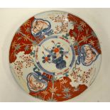A large Japanese Imari charger decorated to the centre with a vase of flowers, Meiji period, 46.