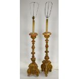 A pair of Italianate carved giltwood torchere lamp bases - as found,