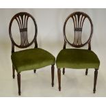 A pair of George III Hepplewhite style fruitwood side chairs having oval backs with moulded pierced