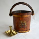 A brass bound coopered munitions bucket bearing an armorial, with leather clad rope handle,
