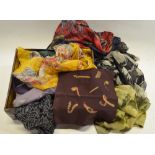 A box containing an assortment of mostly silk scarves,