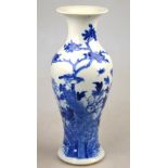 A Chinese 19th century blue and white baluster vase decorated with a bird in a tree, insect, flowers