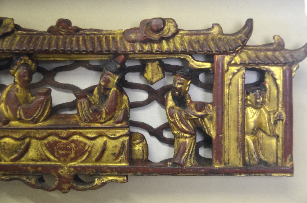 A Chinese red and gilt lacquered wood carving of two seated figures with attendants within a - Image 3 of 5