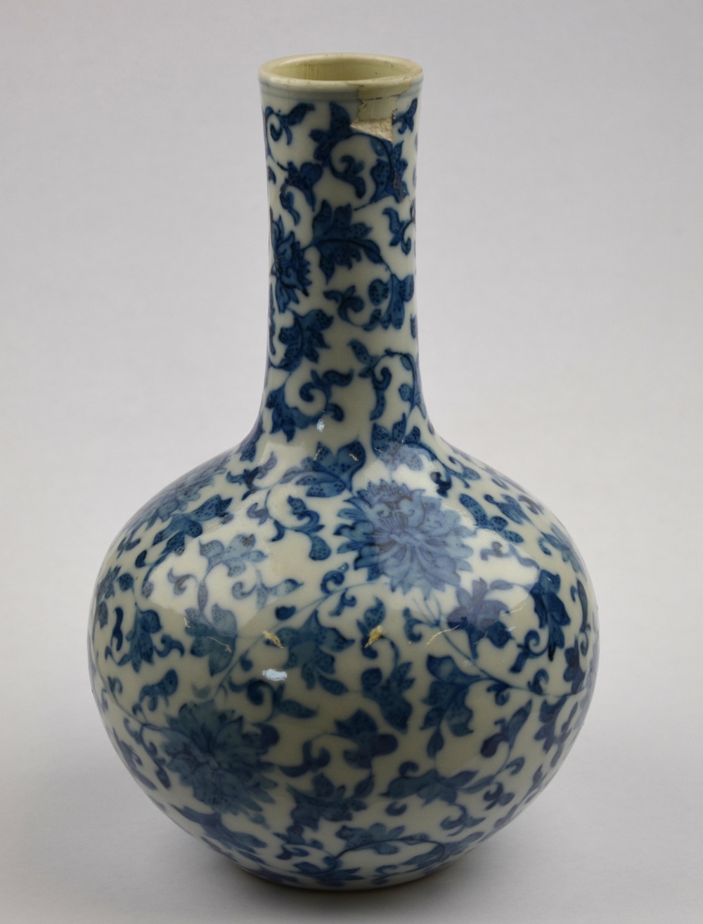 A Chinese blue and white bottle vase decorated with flowers and foliage, Yongzhing seal mark but