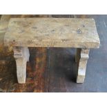 An antique pollard oak small plank stool on shaped supports