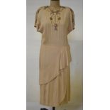 A 1940's pale yellow crepe evening dress with slanting frill to skirt and grey and yellow beaded and