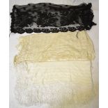 A Spanish black lace fichu and stole and two cream shawls with fringing (4)