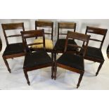 A set of six Regency mahogany rope back dining chairs with drop-in seat pads, raised on turned front