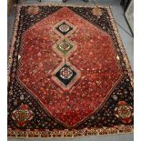 A Persian Shiraz carpet, SW Persia, 2nd half 20th century, nomadic design, on red/dark blue ground,