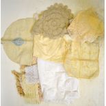 A box containing assorted sets and single doilies with crocheted edging, to/w lace examples,