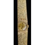 A lady's 9ct gold Accurist wristwatch with gilt dial and textured mesh bracelet strap, 33.