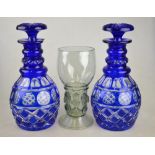 A pair of 19th century blue flash glass decanters with star cut mushroom stoppers, 26 cm to/w a