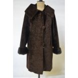 A taupe curled lambskin fur coat, 53 cm across chest, to/w a 1950's faux astrakhan dark brown