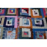 A Victorian log cabin patchwork quilt with multi-coloured fabrics and red satin valance, 160 x 193