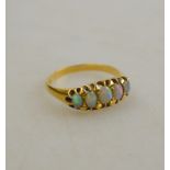 A black opal five stone ring, 18ct yello