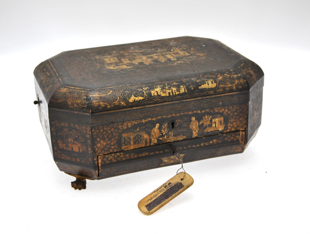 A Chinese 19th century black lacquer octagonal workbox, the hinged cover decorated in gilt with