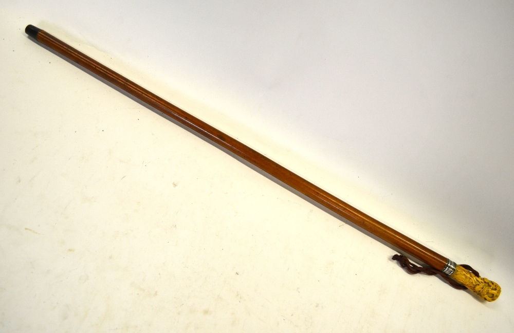 An 18th century malacca walking cane with white metal ferrule and ivory pommel,