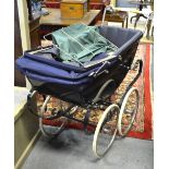 A vintage coach built pram by Davies Baby Carriages Ltd in dark blue livery with matching hood,