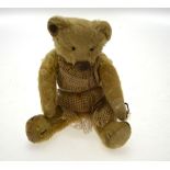 A Chad Valley teddy bear with worn mohair, stud to ear, stitched eyes, nose, mouth and claws,