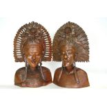 A pair of Balinese carved wood busts with ornate head-dresses,