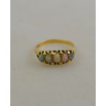 A black opal five stone ring, 18ct yellow gold claw set, size S Condition Report Opals rubbed