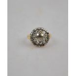 An antique-style diamond cluster ring having central old cut diamond in possibly Georgian foil