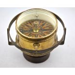 An antique brass cased nautical gimble framed compass,
