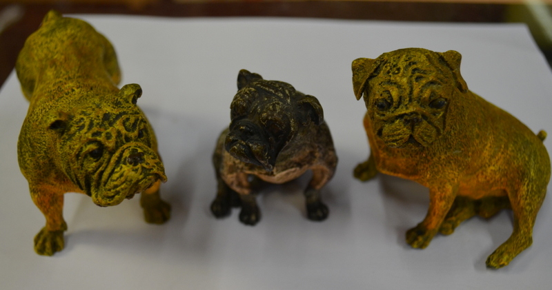 A pair of cold-painted bronze bulldogs, standing and seated, 9 cm high,