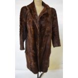 A three-quarter length musquash fur coat with flared sleeves, to/w a pony skin fur coat, both 50