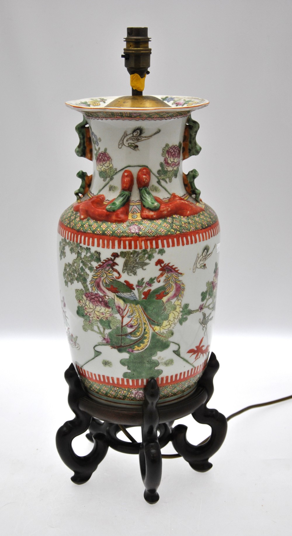 A Chinese famille rose baluster vase decorated with a variety of birds including peacocks, amidst