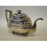 Newcastle Assay: A George III silver oblong teapot of banded design on ball feet, with ivory