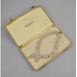 A vintage three row imitation pearl cross over necklace in Ciro of Bond Street box