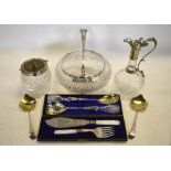 A cut glass bowl with plated rim and matching servers,