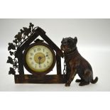 A brown-patinated bronze desk clock, modelled with a bulldog with glass eyes,
