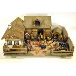 An antique painted wood and cardboard farmstead, to/w a selection of composition animals and figures