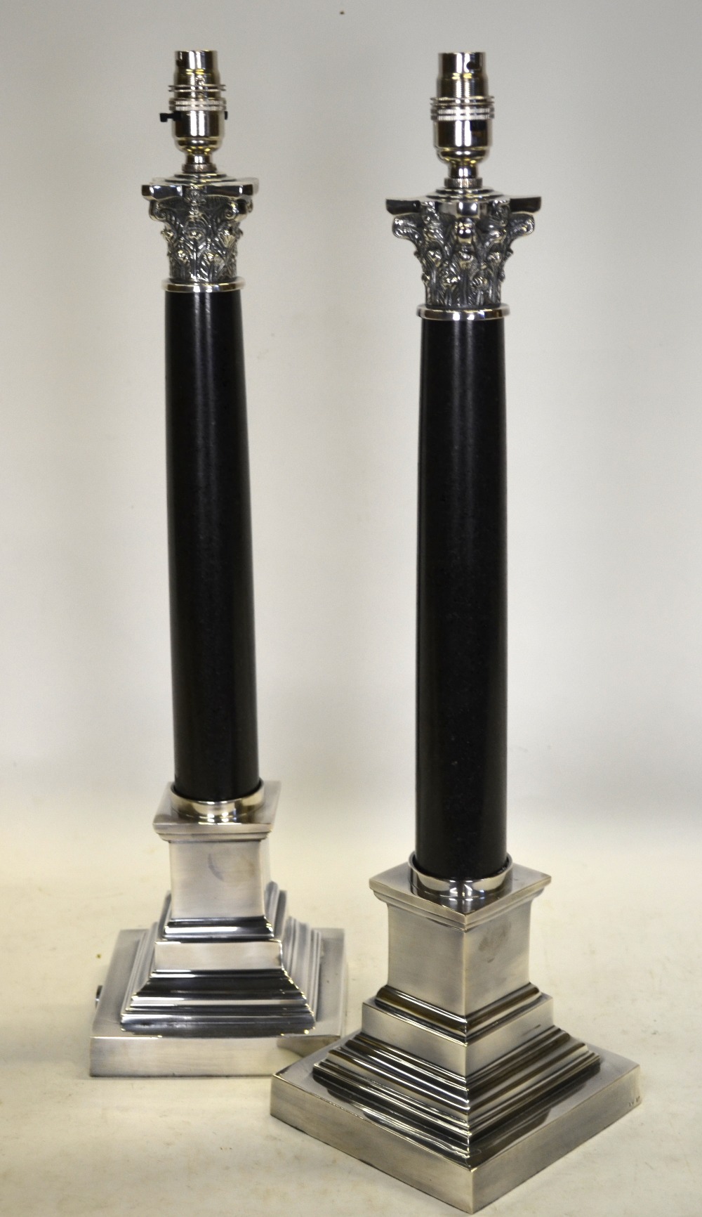 A pair of classical style electroplated and black stone column lamp-bases,