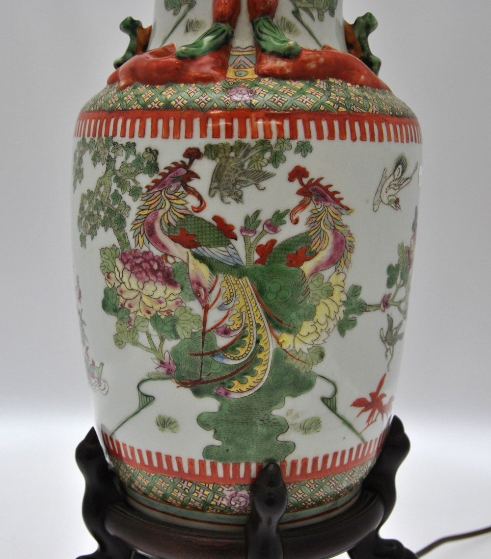 A Chinese famille rose baluster vase decorated with a variety of birds including peacocks, amidst - Image 2 of 4